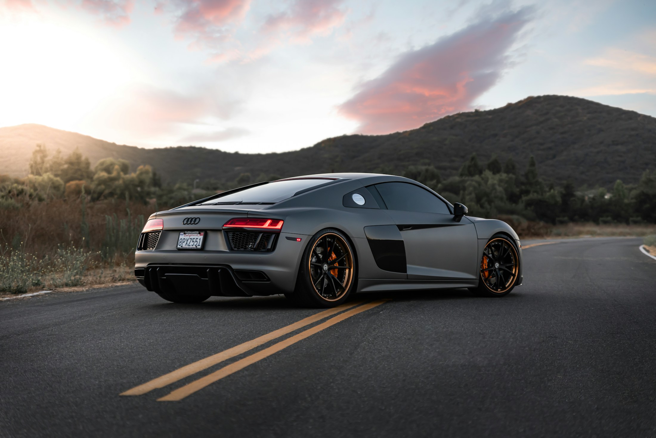 Modified performance car in a wide road scene